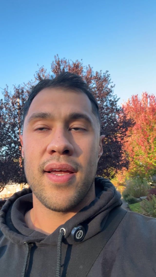 Spencer King outdoors in front of an autumn tree